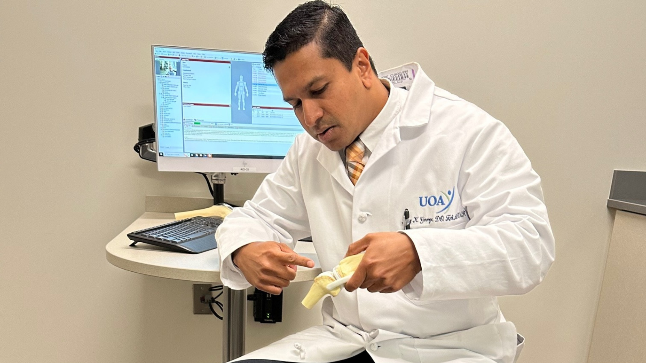 physiatrist pointing at a bone